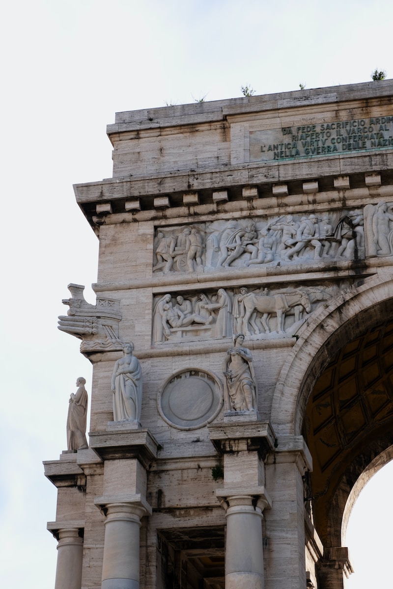 a large stone arch with statues on it