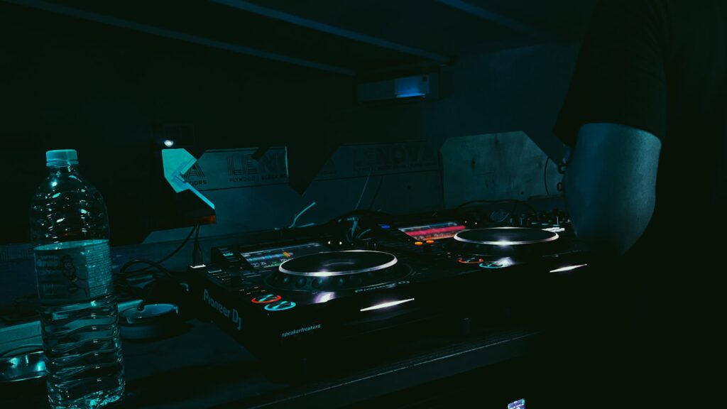 a dj mixing music in a dark room