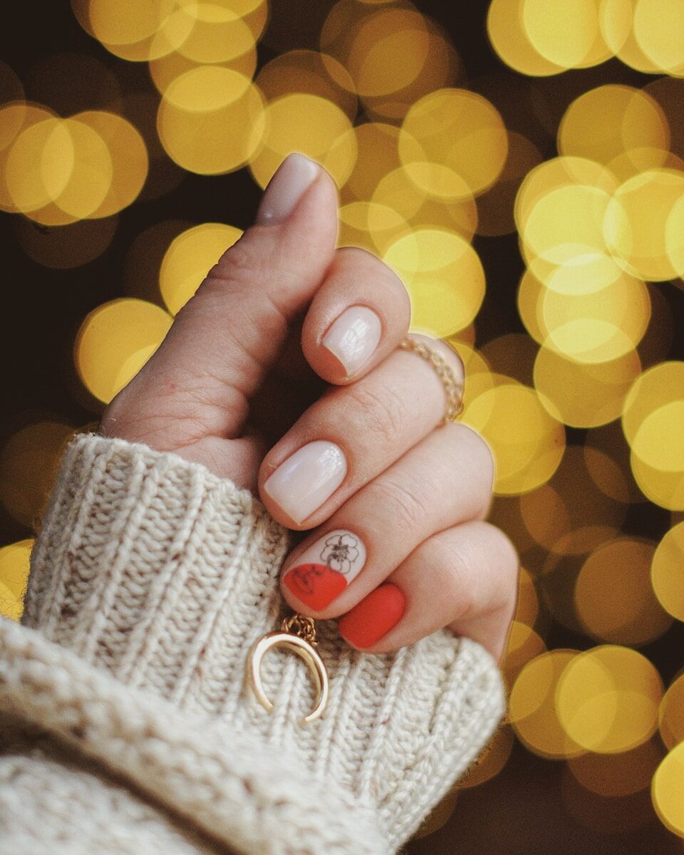 gold-colored hoop earring on human hand