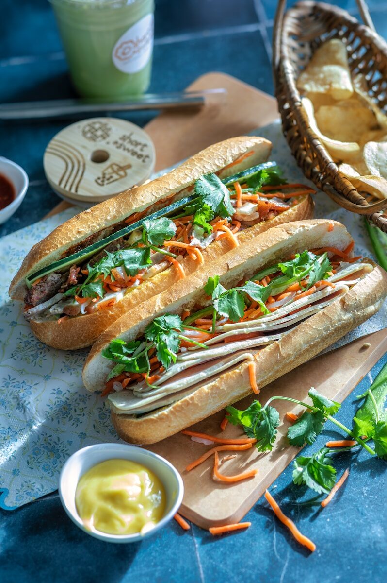 a couple of sandwiches sitting on top of a cutting board